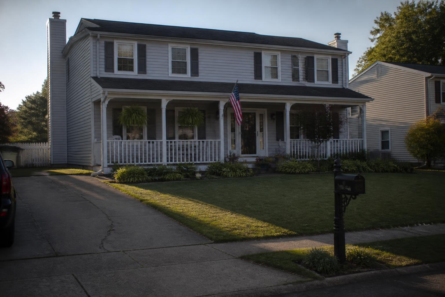 American suburban home with a new roof and well-kept lawn